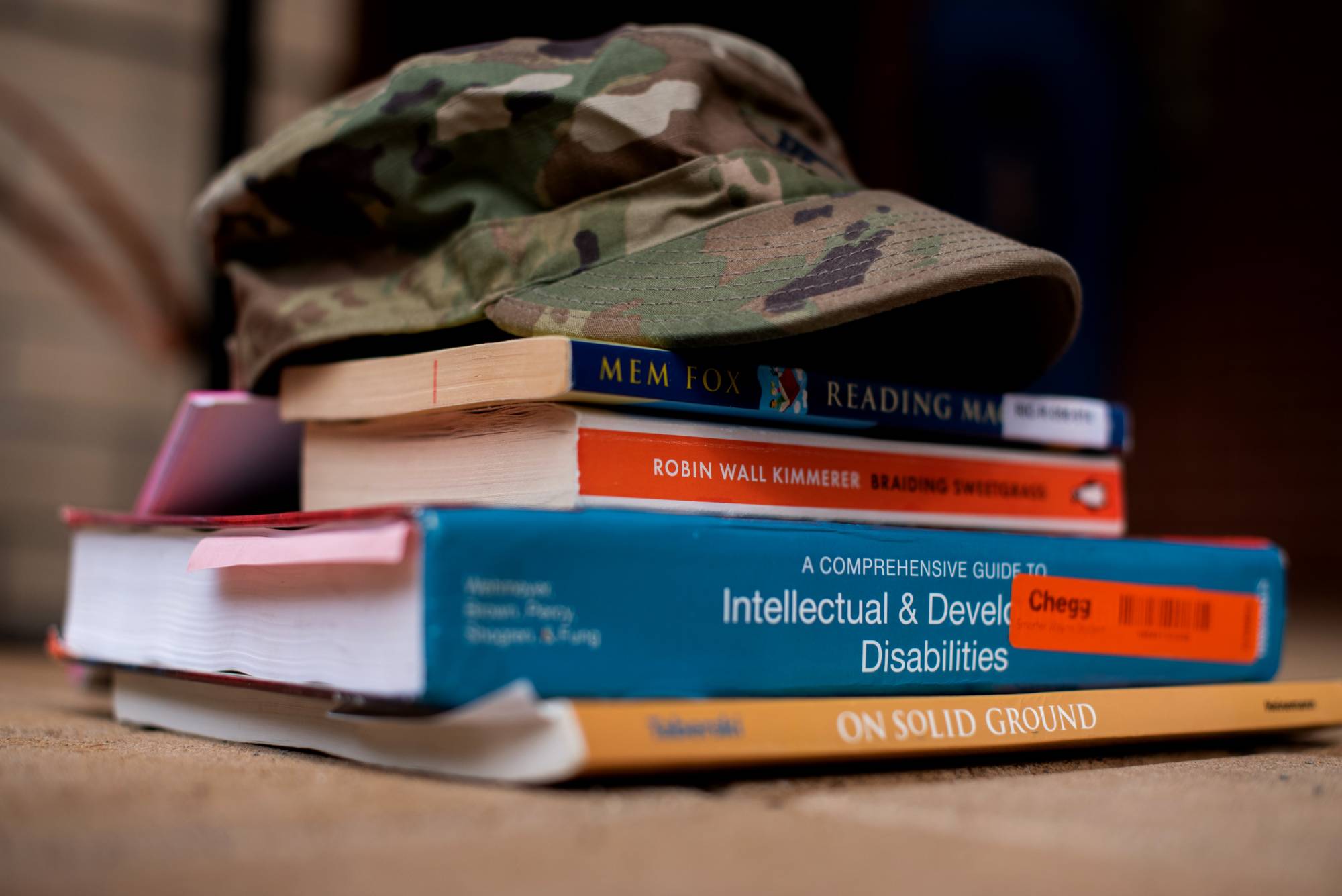 GVSU Student Veteran hat on top of textbooks